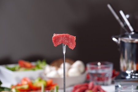 meat on a fondue forkの写真素材