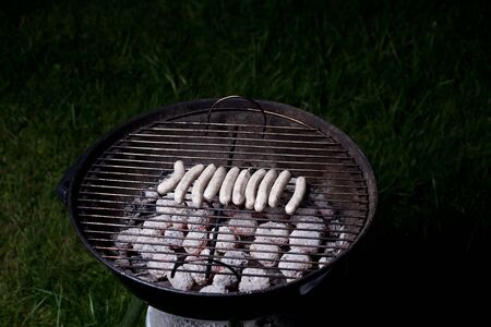 frankonian sausages on a charcoal grillの写真素材
