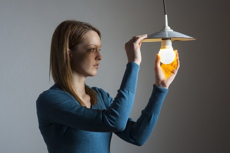 young woman with a light bulbの写真素材