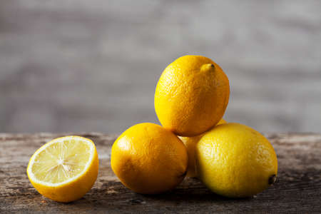 raw ripe lemons on woodの写真素材