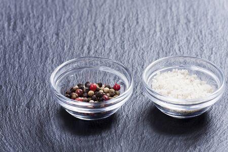 salt and pepper in glass bowlsの写真素材