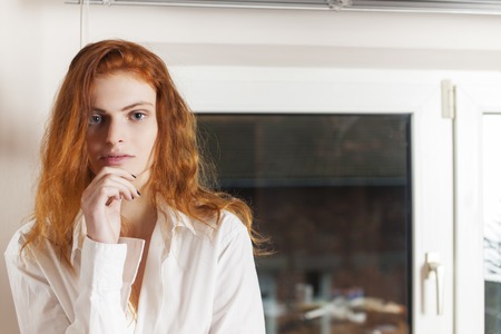 pensive redhead in the kitchenの写真素材