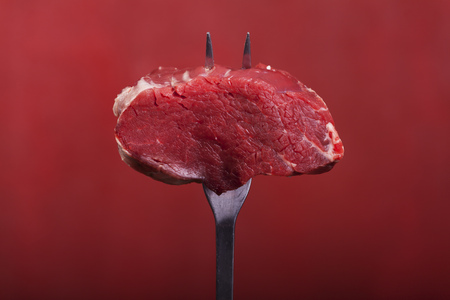 steak on a meat forkの写真素材