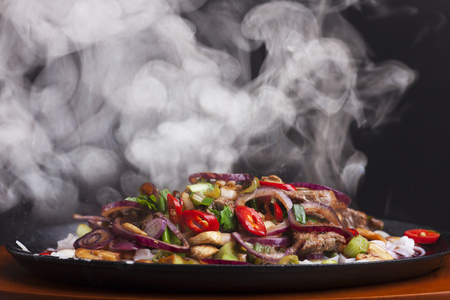 steaming chicken sizzler with noodlesの写真素材