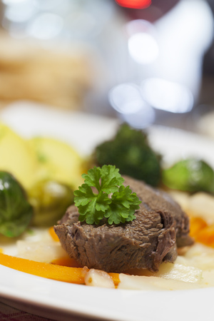 tafelspitz meat on a plate with vegetables の写真素材