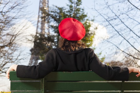 young woman with a beret and the eiffel tower の写真素材