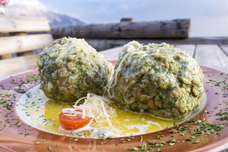austrian spinach dumplings on a table の写真素材