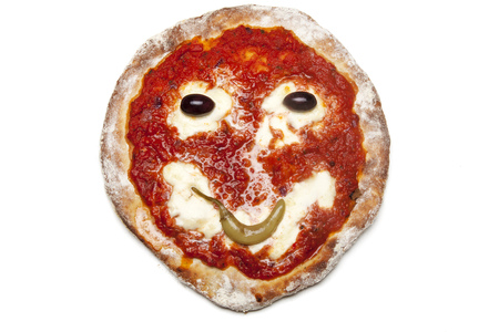 smiley on a backed pizza の写真素材