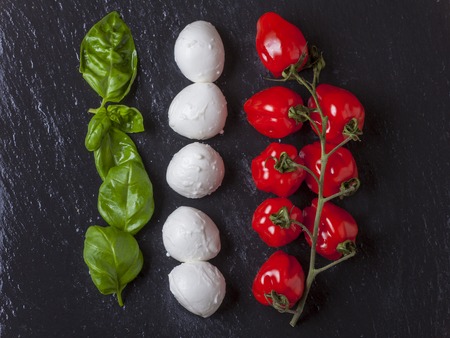ingredients of insalada caprese on black slate の写真素材