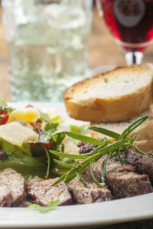 slices of a steak on fresh saladの写真素材