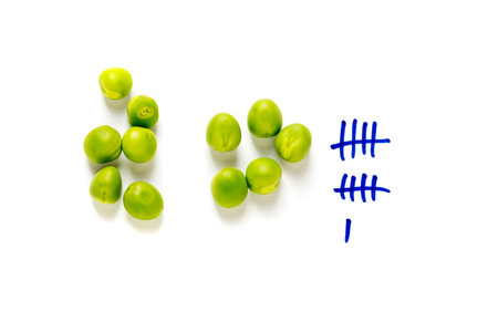 counting peas on white background