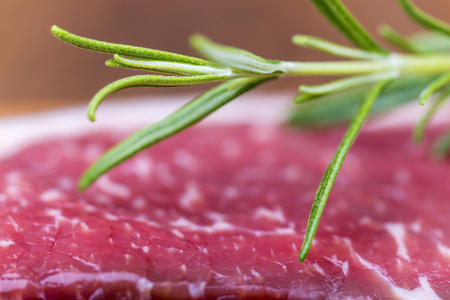 closeup of raw steak with rosemaryの写真素材