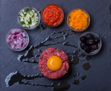 steak tartare with an egg on slate の写真素材