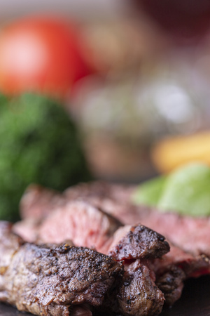 slices of a grilled steak on slateの写真素材