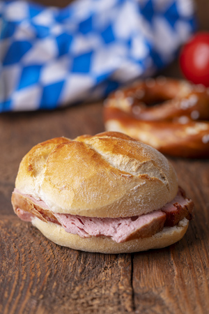 closeup of a bavarian leberkaese bun on dark woodの写真素材