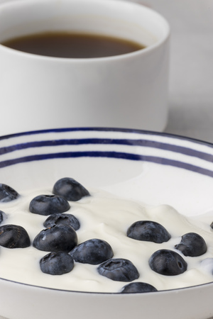 blueberries on yoghurt and coffeeの写真素材