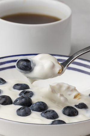 blueberries on yoghurt and coffeeの写真素材