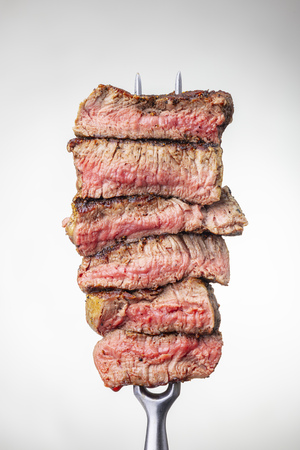 slices of a steak on a forkの写真素材