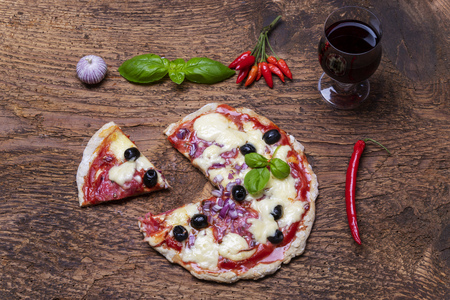 overview of a pizza with wineの写真素材