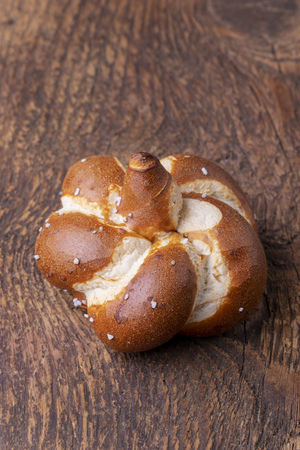 single bavarian pretzel on woodの写真素材