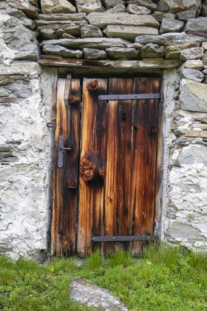 rustic wooden door on an alpine hutの写真素材