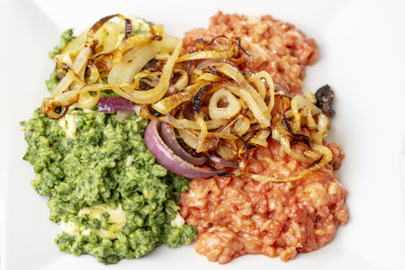 beetroot and spinach spaetzle on a plateの写真素材