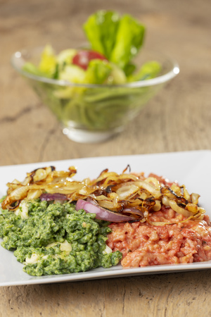 beetroot and spinach spaetzle on a plateの写真素材