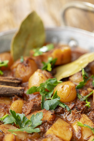 greek stifado on dark woodの写真素材