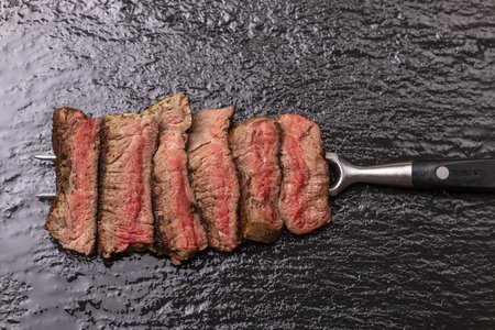 slices of a steak on a forkの写真素材