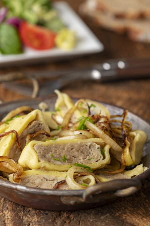 swabian maultasche with onions in a pan の写真素材
