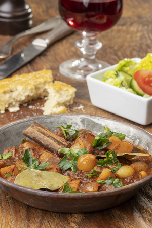 greek stifado on dark woodの写真素材