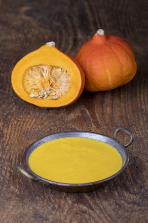 closeup of pumpkin soup on woodの写真素材