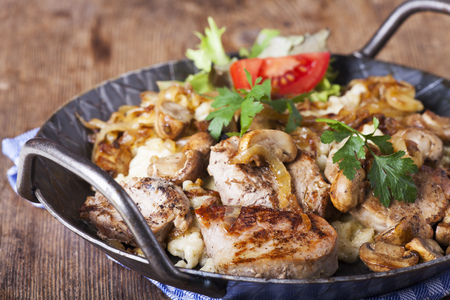 pork fillet on spaetzle with mushroomsの写真素材