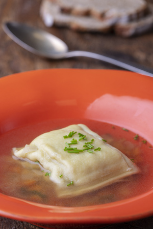swabian maultasche in broth on woodの写真素材