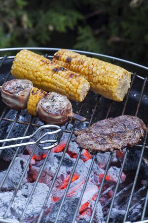 meat and corn on the grillの写真素材