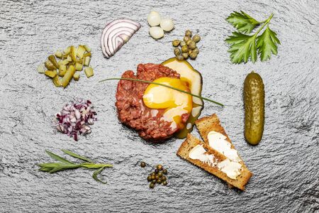 raw steak tartare on black slateの写真素材
