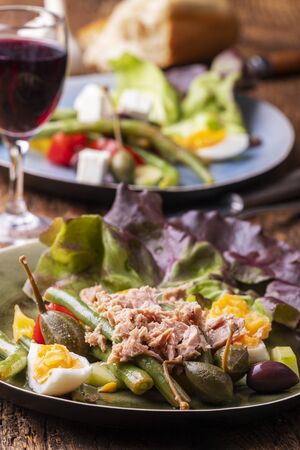 closeup of salade nicoise on dark wood の写真素材