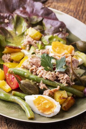 closeup of salade nicoise on dark woodの写真素材