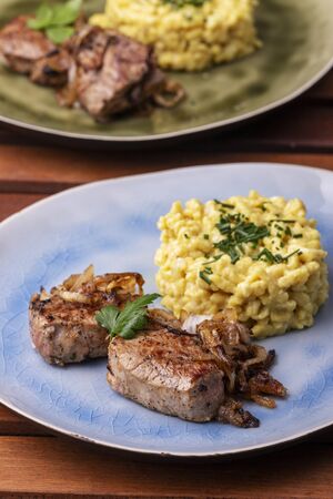 roasted pork fillet and spaetzle in a plateの写真素材