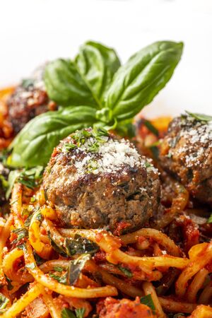 spaghetti with meat balls on dark woodの写真素材