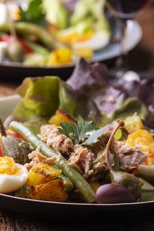 closeup of salade nicoise on dark woodの写真素材