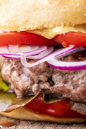 closeup of a hamburger on woodの写真素材