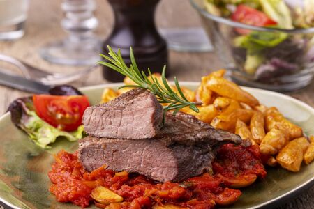 grilled steak on a plate with rosemaryの写真素材