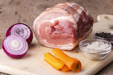 raw rolled pork on cutting boardの写真素材