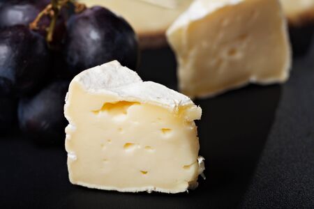 closeup of swiss cheese with grapes and wineの写真素材