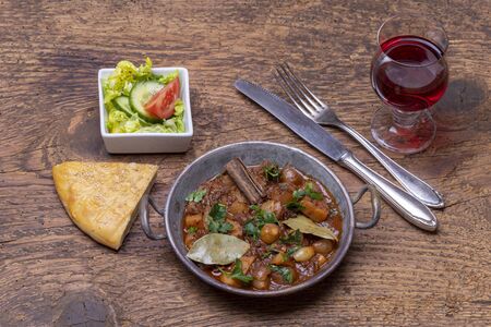 greek stifado on dark woodの写真素材