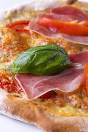 detail of a pizza with ham and basilの写真素材