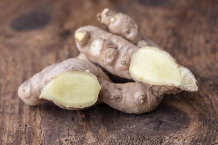 fresh ginger on dark woodの写真素材