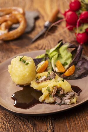stuffed potato dumplings with salad on woodの写真素材