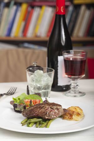 slices of a steak on wood with rosemaryの写真素材